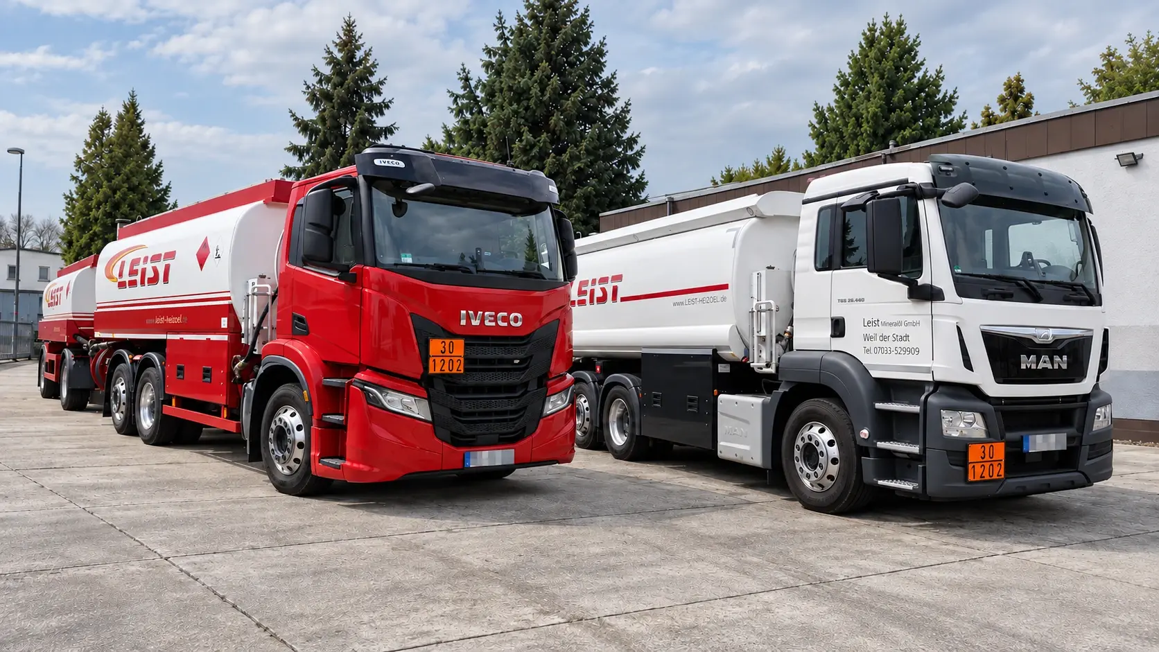 Ein roter Iveco- und ein weißer MAN-Tankwagen von Leist auf dem Betriebsgelände